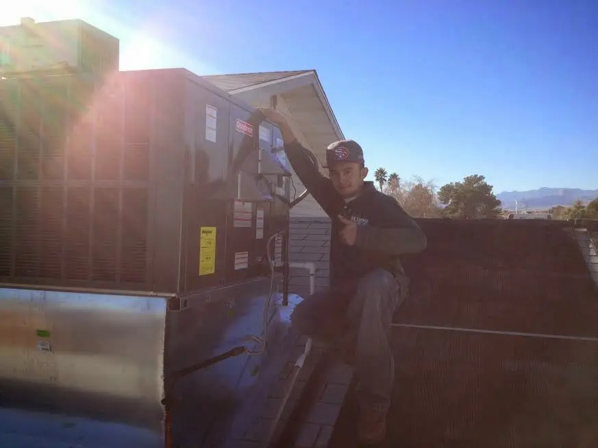 HVAC technician performing AC Tune-Up on a rooftop unit in Aquia Harbour